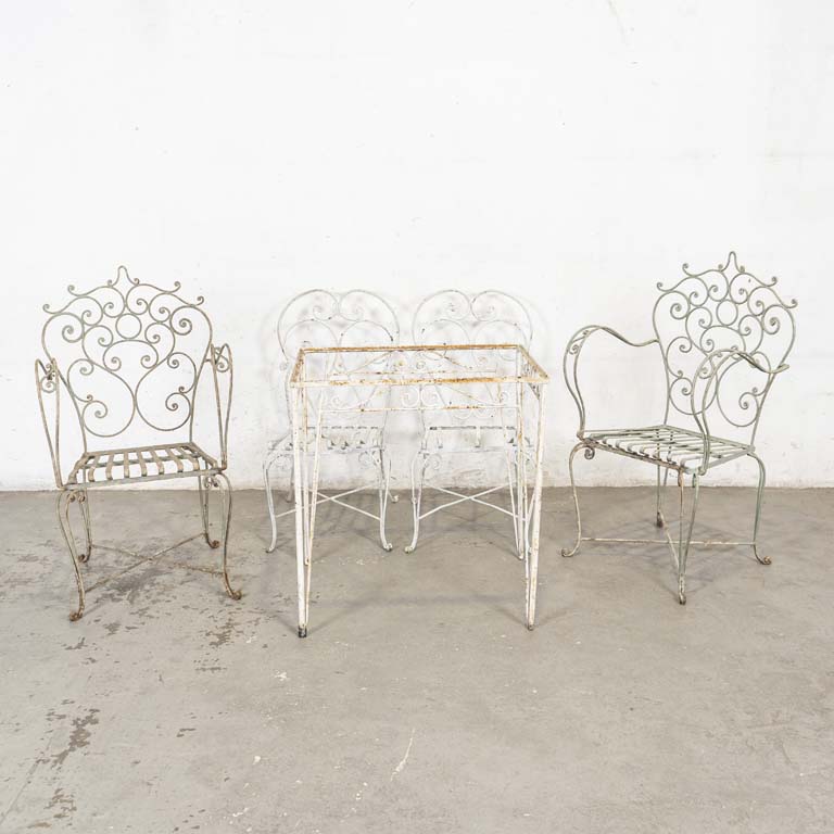 Cinco piezas de jardín (diferentes), en hierro: mesa (sin tapa), dos sillas y dos sillones. Faltan planchuelas de los asientos, superficie con óxido y con detalles. - Medidas: 70x51x74cm